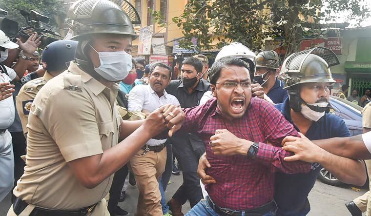 Police detain an activist during BJP's march towards Kolkata Police headquarters to protest against the alleged violence during the West Bengal Municipality polls | PTI