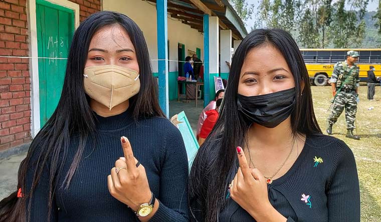 Women show their fingers marked with indelible ink after casting their votes | PTI