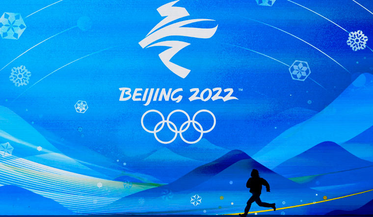 A performer runs across the stage during a rehearsal for the medal ceremonies ahead of the 2022 Winter Olympics in Beijing | AP