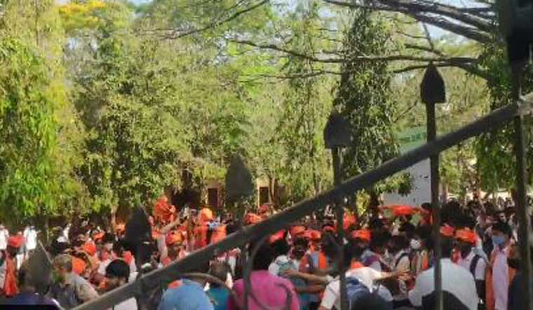 [File] Students wearing saffron shawl protest against hijab outside the MGM College in Udupi | Screengrab via Twitter