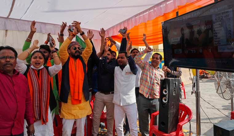 Bharatiya Janata Party (BJP) workers celebrate early leads for the party as election officials count votes after UP state elections | PTI