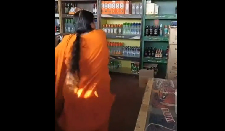 Uma Bharti hurling a stone at liquor bottles at an outlet in Bhopal | Video grab / Twitter