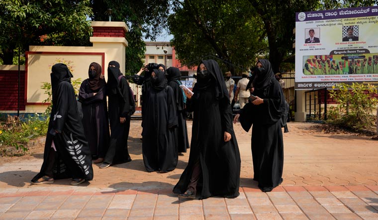 Muslim students wearing burqas leave Mahatma Gandhi Memorial college in Udupi after they were denied entry into the campus | AP
