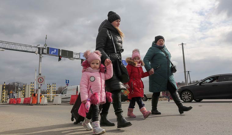 A family arrives at the border crossing in Medyka, Poland after fleeing from Ukraine | AP