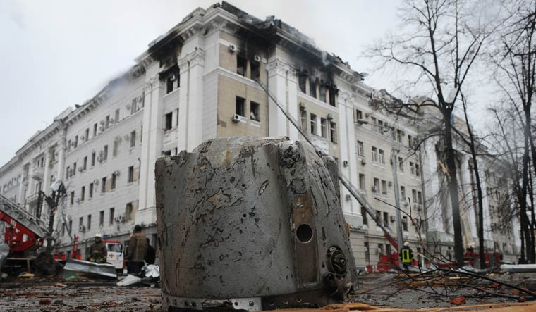A rocket fragment lies on the ground next to a building in Kharkiv | AP