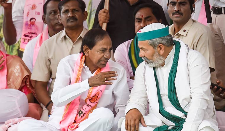 Telangana Chief Minister K. Chandrashekar Rao with Bharatiya Kisan Union leader Rakesh Tikait during a sit-in protest against Centre's paddy procurement policy in New Delhi | PTI