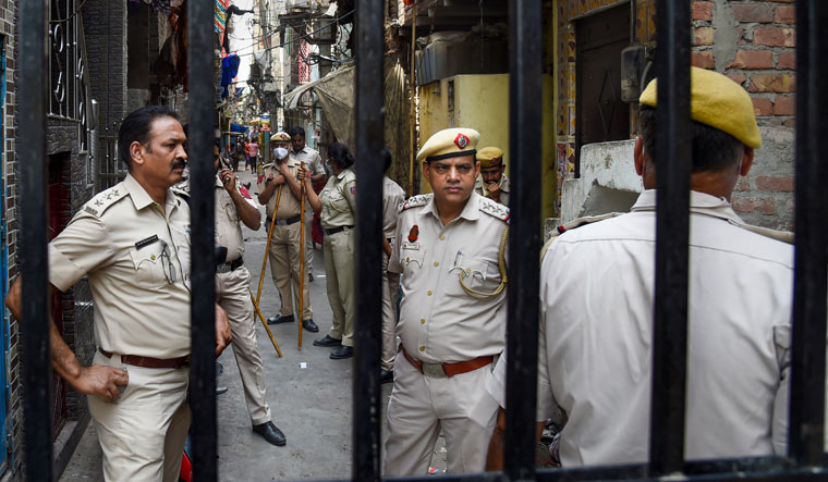 Police personnel keep vigil after clashes broke out between two communities at Jahangirpuri in Delhi | PTI