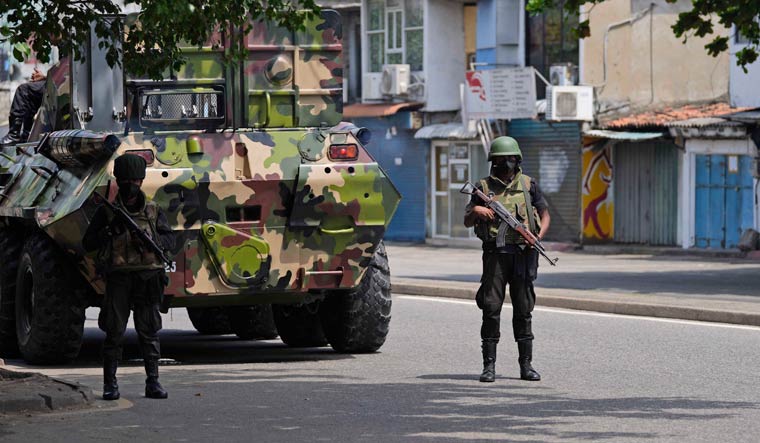 Sri Lankan soldiers patrol during curfew in Colombo | AP