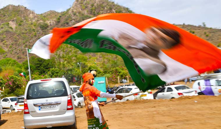 A Congress supporters waves a huge flag at the venue of Chintan Shivir in in Udaipur | Arvind Jain