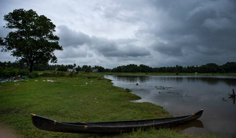 A country boat anchored at a marshy land on a rainy day in Kochi | AP