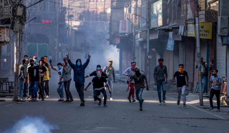 Young men clash with security forces during a protest against sentencing of Kashmiri separatist leader Yasin Malik, in Srinagar | AP