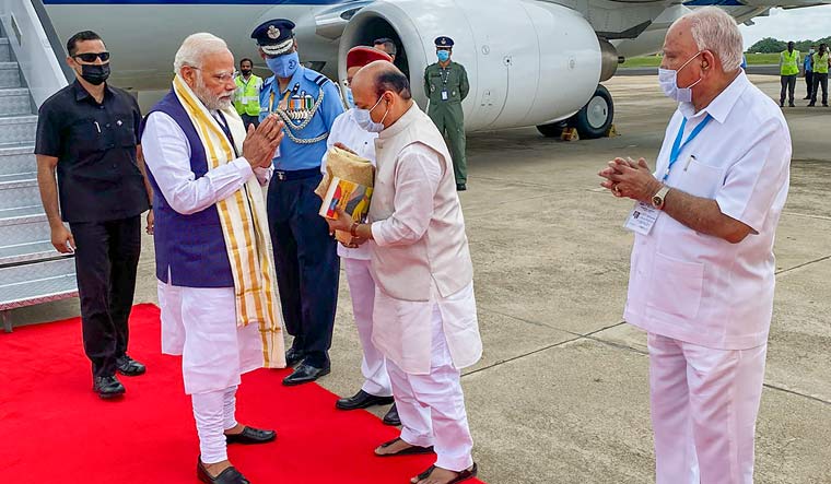  Prime Minister Narendra Modi being welcomed by Karnataka Chief Minister Basavaraj Bommai upon his arrival, in Bengaluru. Karnataka Governor Thaawarchand Gehlot is also seen | Twitter
