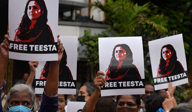 Demonstrators hold placards during a protest against Teesta Setalvad's arrest in Mumbai | AFP