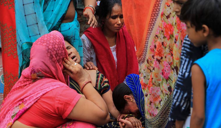 Family members mourn during the funeral procession of tailor Kanhaiya Lal in Udaipur | PTI