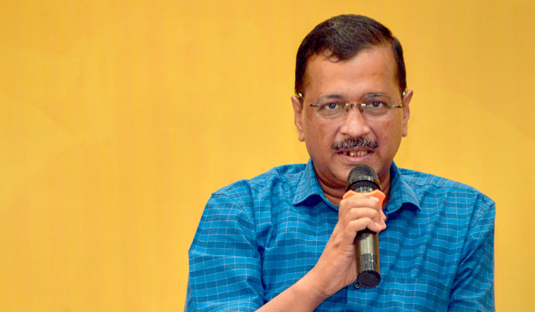 Delhi Chief Minister and AAP Convener Arvind Kejriwal speaks during a meeting with traders and businessmen in Rajkot | PTI