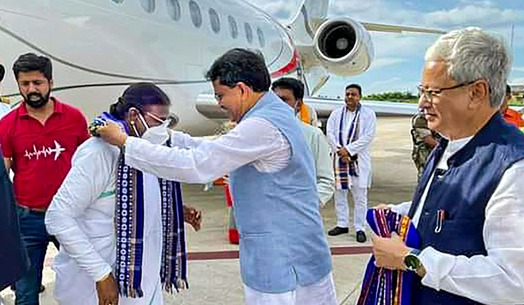 Tripura Chief Minister Manik Saha welcomes NDA's presidential candidate Droupadi Murmu upon her arrival, in Agartala | PTI