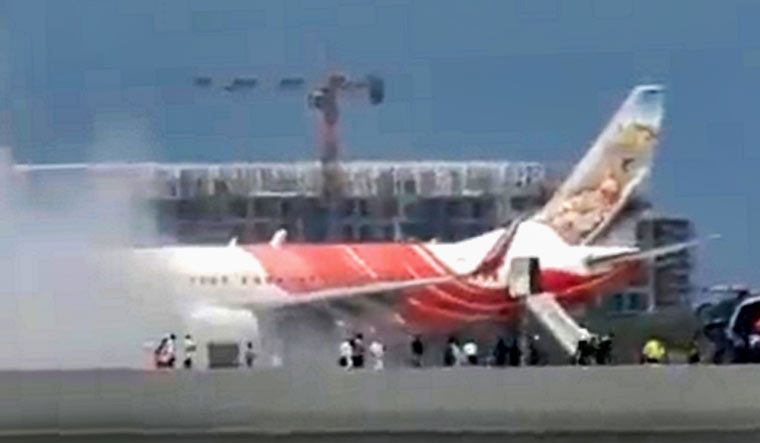 Smoke billows from an Air India Express plane at Muscat airport | PTI