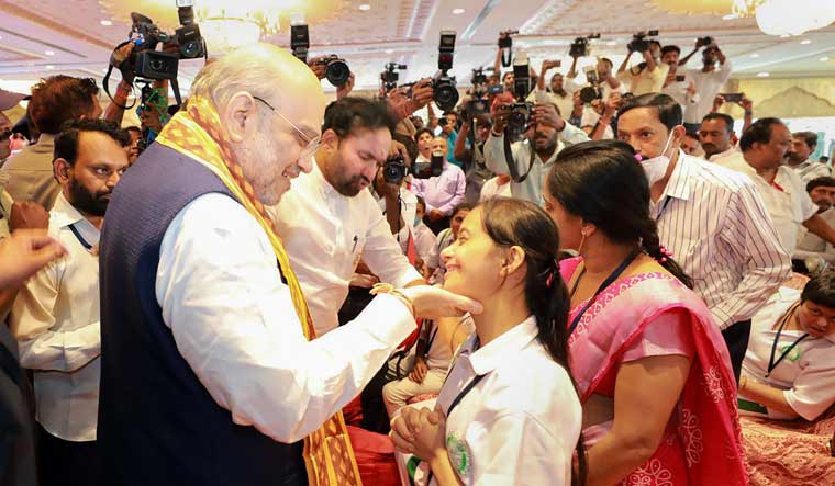 Union Home Minister Amit Shah interacts with a child with disability during the 'Sewa Diwas' programme, organised on the occasion of Prime Minister Narendra Modi's birthday, in Hyderabad | PTI
