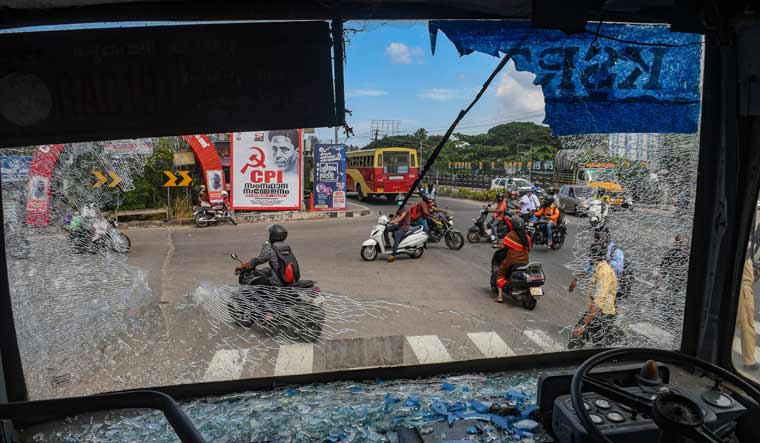 Broken windshield of a Kerala State Road Transport Corporation bus after some miscreants threw stones on it during a hartal called by the Popular Front of India | PTI