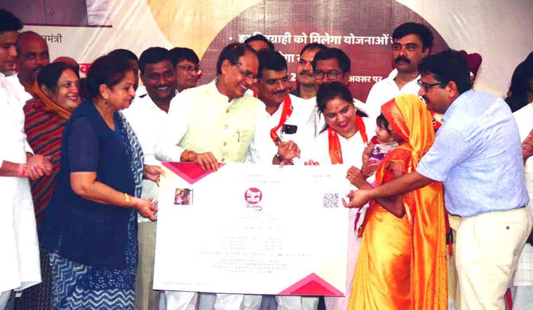 Madhya Pradesh Chief Minister Shivraj Singh Chouhan distributes certificates to the beneficiaries of Ladli Laxmi Yojana