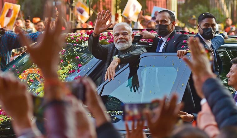 Prime Minister Narendra Modi waves at supporters during a roadshow in Delhi | Rahul R. Pattom