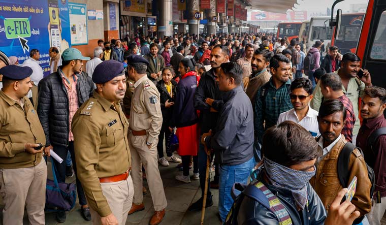 Candidates wait to board specially arranged buses after the junior clerk's exam was cancelled due to paper leak, in Ahmedabad | PTI