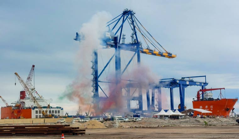 Colored fumes rise in the sky as the first ship carrying port equipment given an official reception at Vizhinjam International Seaport Limited, in Thiruvananthapuram | PTI