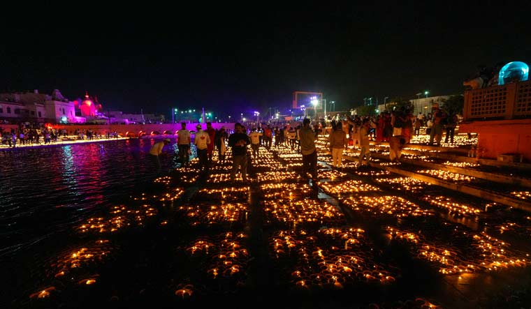People light earthen lamps at Ram ki Pouri during Deepotsav in Ayodhya | PTI