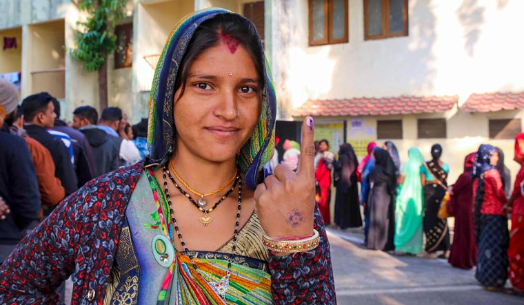 A voter shows her finger marked with indelible ink after casting vote for the Madhya Pradesh Assembly elections, in Bhopal | PTI