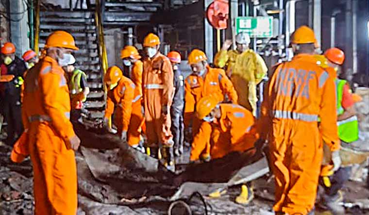 NDRF personnel during a search and rescue operation after a fire broke out following an explosion at a pharmaceutical company, in Maharashtra's Raigad district | PTI