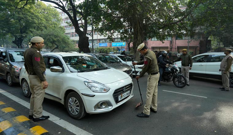 Security personnel check a vehicle near the Parliament House | PTI