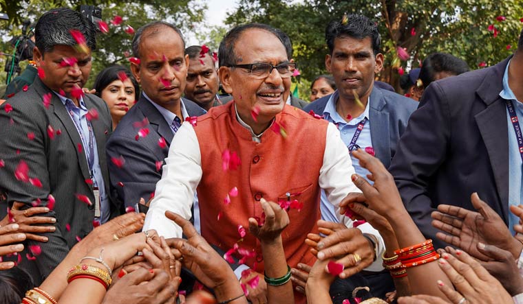 Madhya Pradesh Chief Minister Shivraj Singh Chouhan with BJP workers and supporters celebrates the party's victory in the assembly elections | PTI
