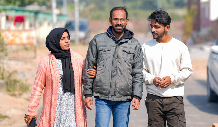 Journalist Siddique Kappan with his wife Raihana and son Muzammil after his release from the Lucknow | PTI