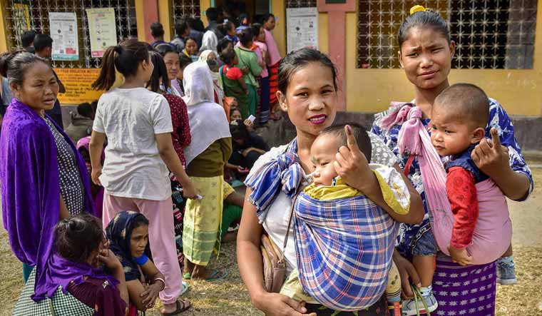  Women voters show their fingers marked with indelible ink after casting their votes at a polling booth in Ri Bhoi district of Meghalaya | PTI