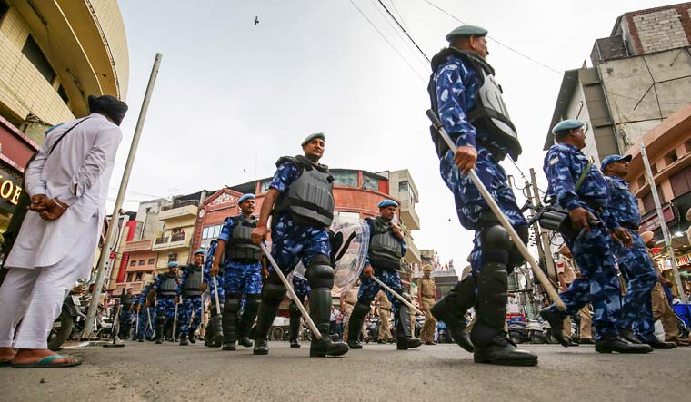 Police personnel flag march amid a crackdown against 'Waris Punjab De' chief Amritpal Singh and his aides, at Heritage street near the Golden Temple, in Amritsar | PTI