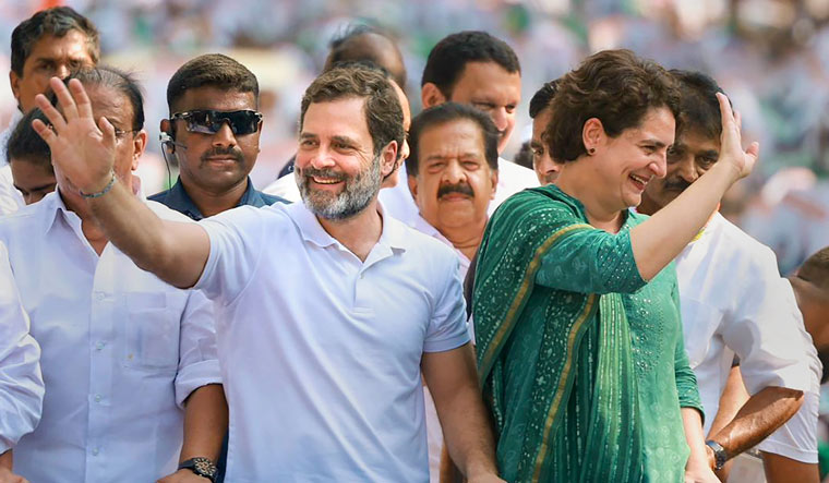 Congress leaders Rahul Gandhi and Priyanka Gandhi wave at supporters during a roadshow in Wayanad | PTI