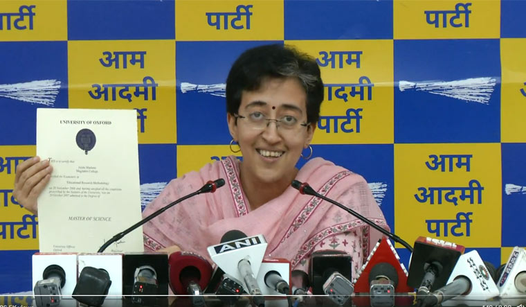 AAP leader Atishi shows her degree certificate at a press conference in Delhi | Video grab/Twitter