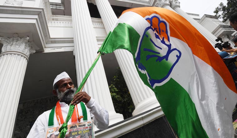 A Congress worker celebrates party's impressive performance in Karnataka assembly elections, in front of the KPCC office in Bengaluru | Banu Prakash Chandra