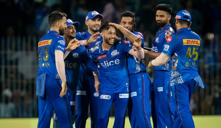 Mumbai Indians' Akash Madhwal, center, is congratulated by teammates as they celebrate their team's win against Lucknow Super Giants | AP