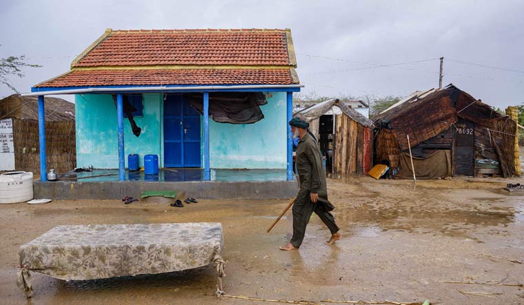 A man walks through deserted Ashira Vandh village following evacuations as part of precautionary measures ahead of the landfall of Cyclone Biparjoy, near Jakhau port in Kutch district | PTI