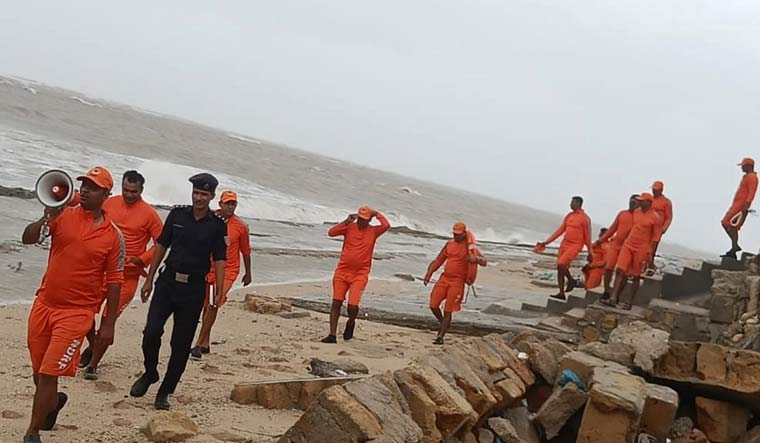 An NDRF personnel makes announcements as precautionary measures ahead of the landfall of Cyclone Biparjoy | PTI