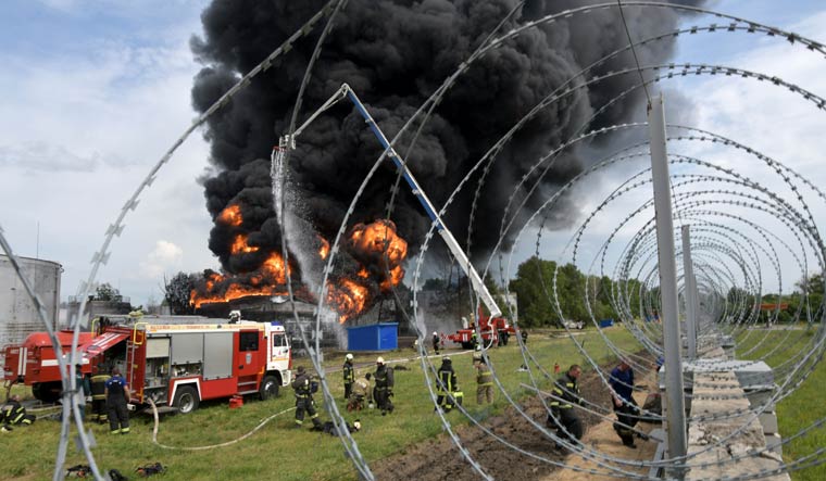 Firefighters work on extinguishing a fire after reports an explosion hit a fuel depot in Voronezh, Russia | AP