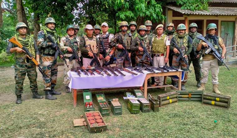 Security personnel pose with recovered weapons after the Area Domination Operations in Manipur | PTI
