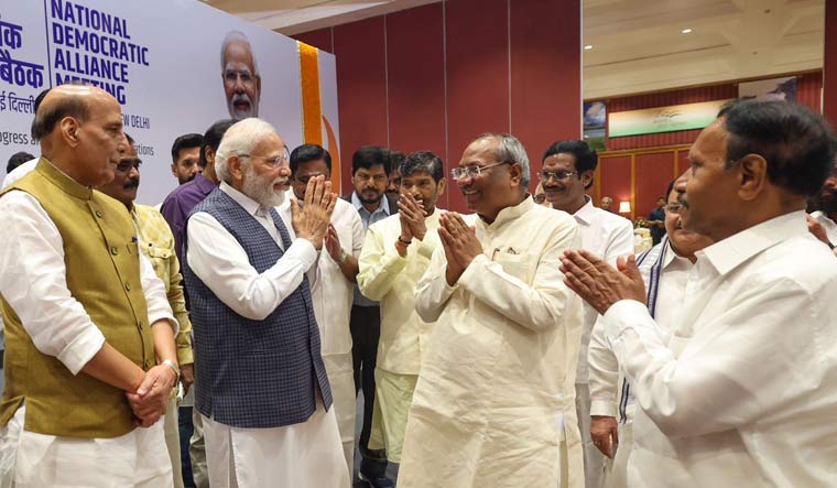 Prime Minister Narendra Modi exchanges greetings with Nishad Party leader Sanjay Nishad and other NDA leaders before the NDA meeting in Delhi | PTI