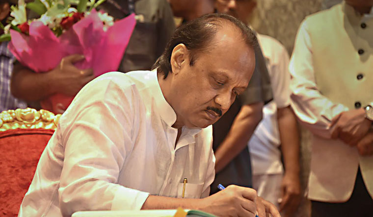 NCP leader Ajit Pawar signs documents after taking oath as Maharashtra Deputy Chief Minister | PTI