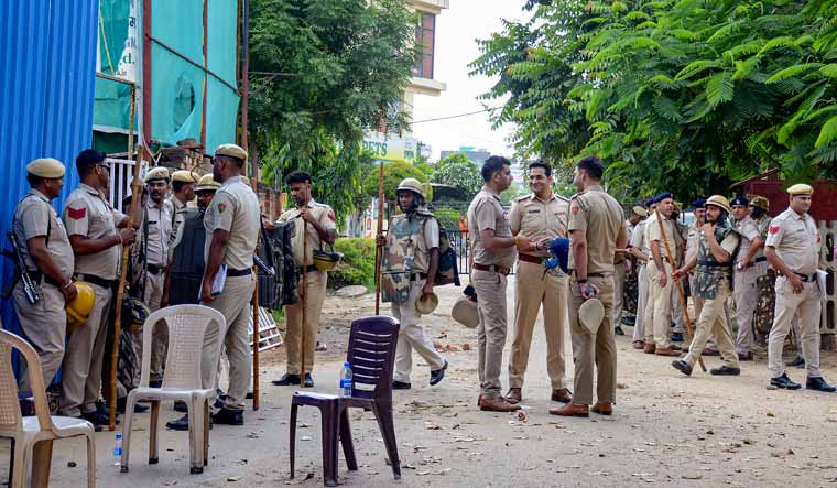 Police personnel outside Anjuman Mosque which was set ablaze in the Sector 57 area, in Gurugram district | PTI