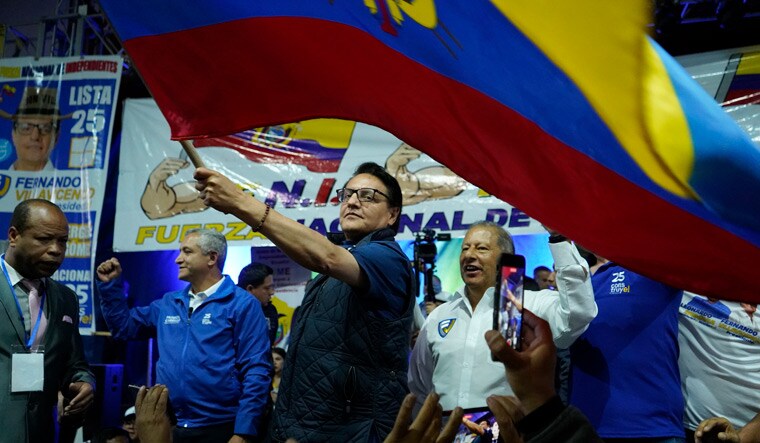 Presidential candidate Fernando Villavicencio waves an Ecuador national flag during a campaign event at a school minutes before he was shot to death outside the same school at Quito in Ecuador | AP