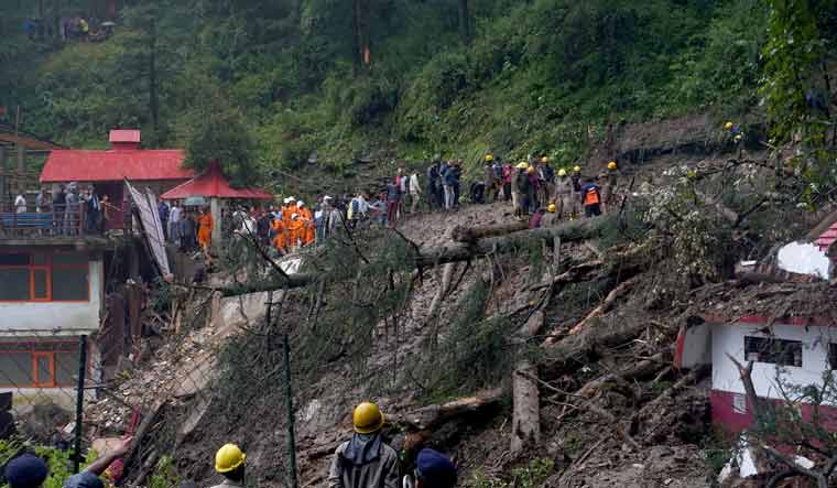 Rescue workers remove the debris as they search for survivors after a landslide in Shimla | Reuters