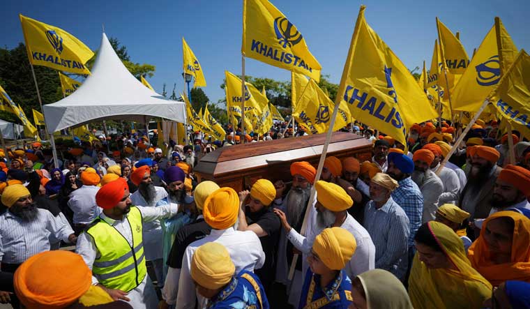 Mourners carry the casket of Sikh community leader Hardeep Singh Nijjar during Antim Darshan, the first part of a day-long funeral service for him, in Surrey, British Columbia on June 25 | AP