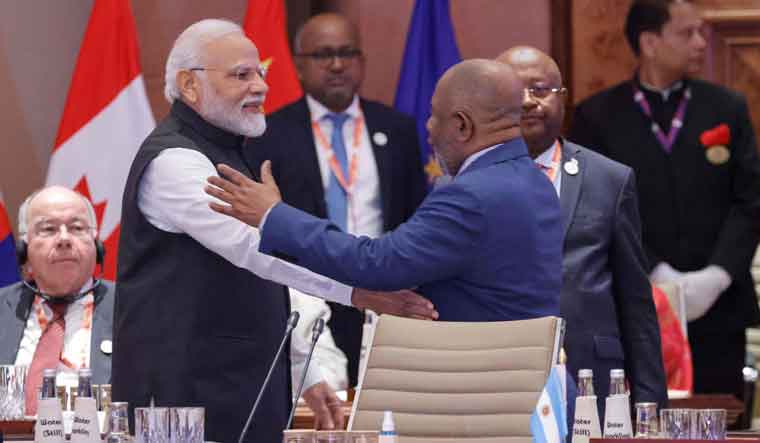 African Union Chairman and Comoros President Azali Assoumani (R) and India's Prime Minister Narendra Modi gesture during the first session of the G20 Leaders' Summit at the Bharat Mandapam in New Delhi | AFP